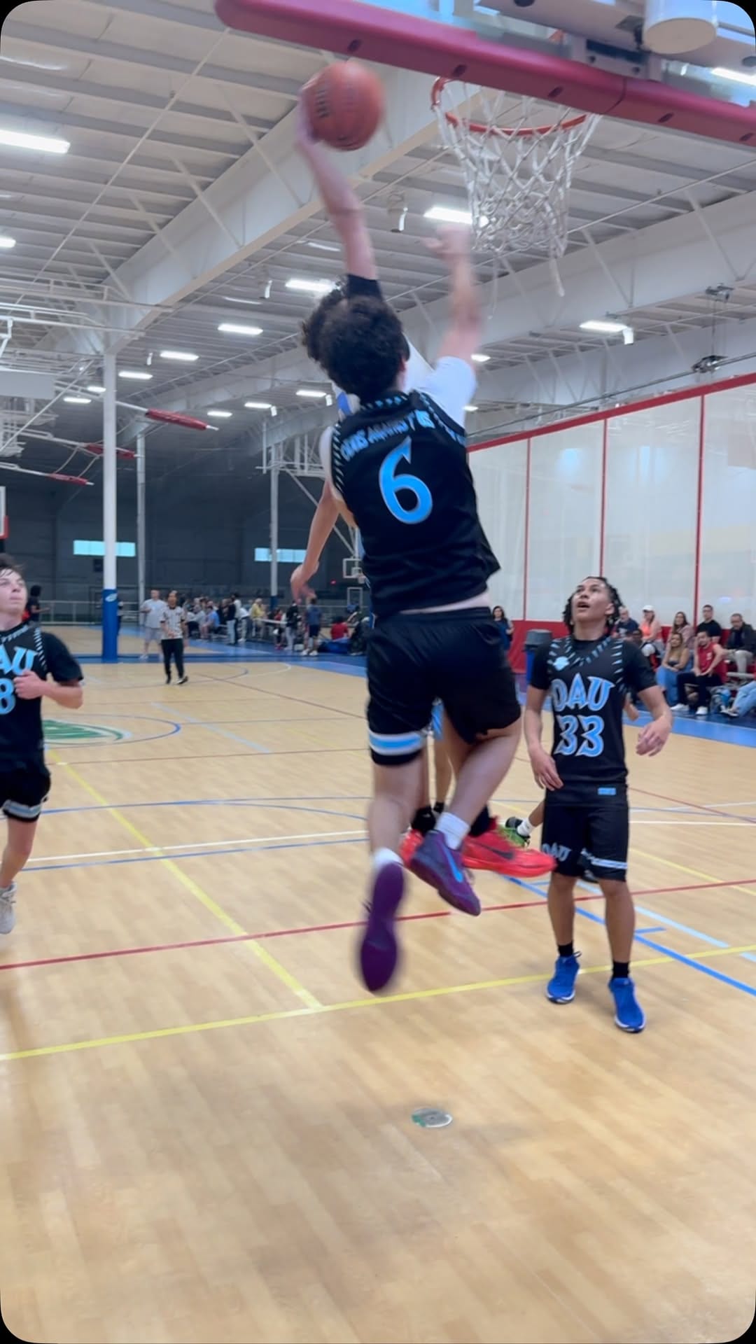 We All Hoop AAU player at the rim during a game
