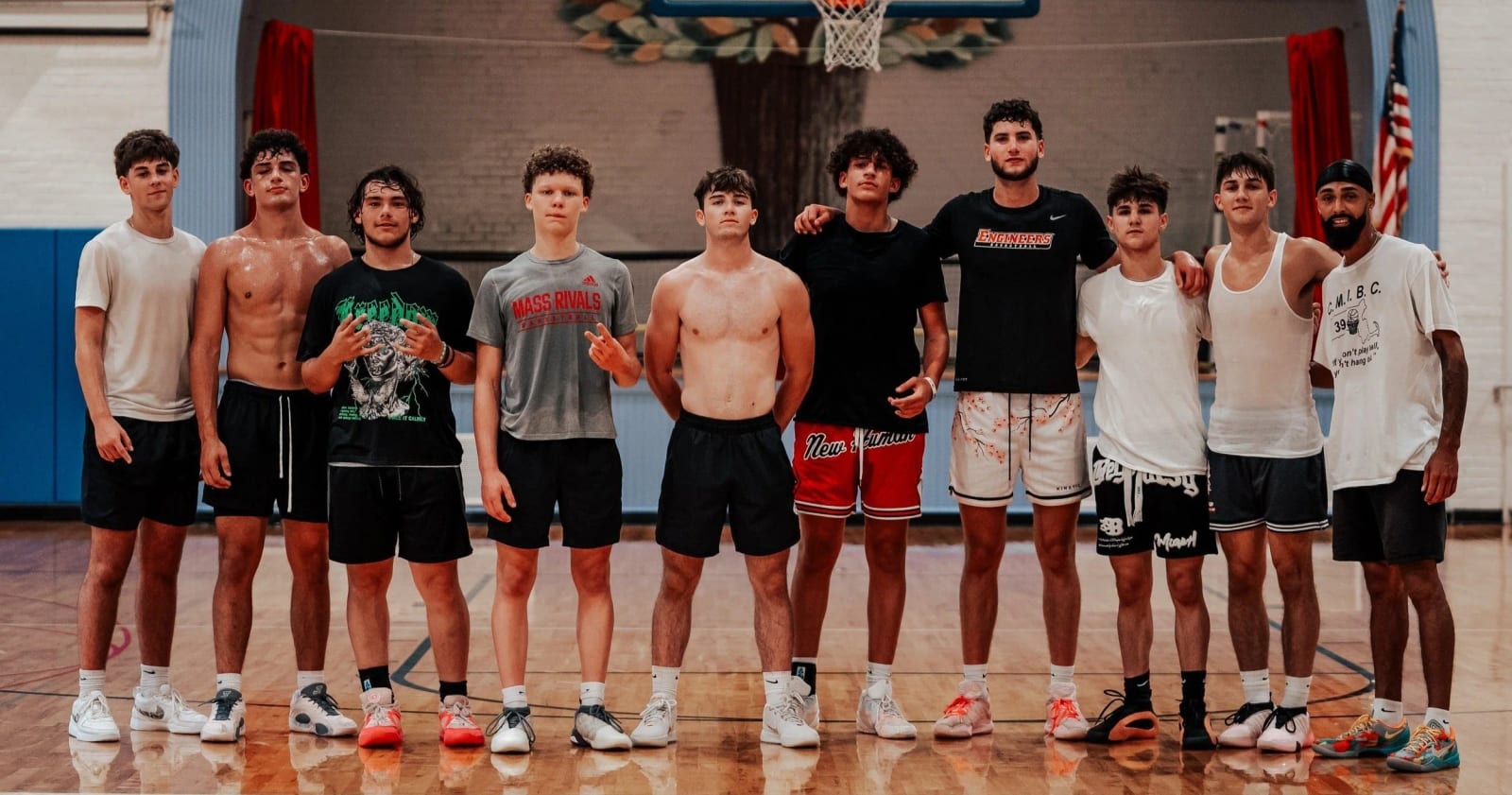We All Hoop high school players lined up on the court with their coach
