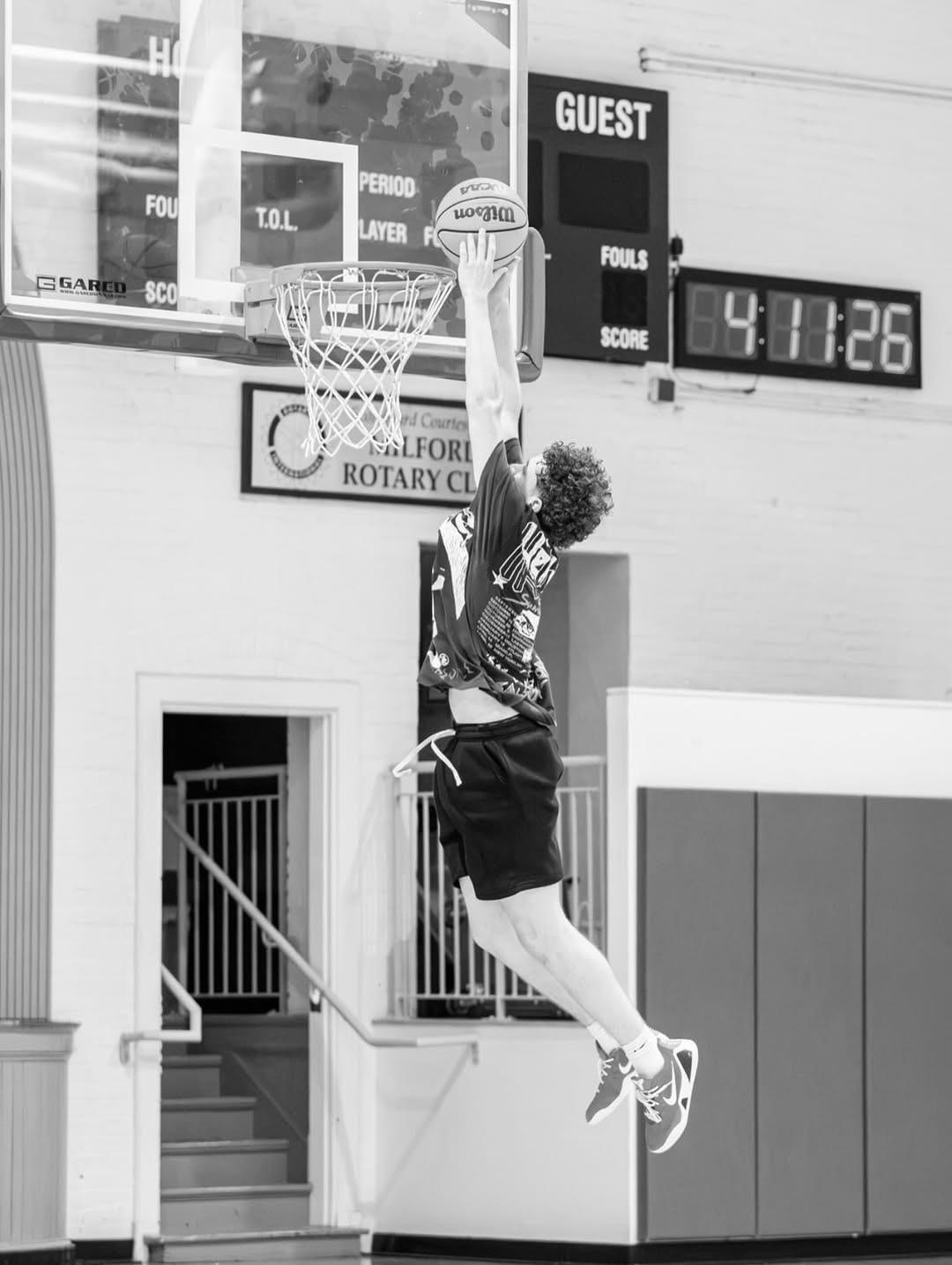 Player finishing at the rim in black and white